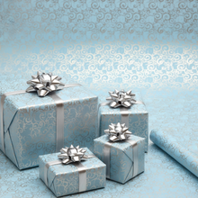 Load image into Gallery viewer, Roll of light blue paper with silver decorative pattern
