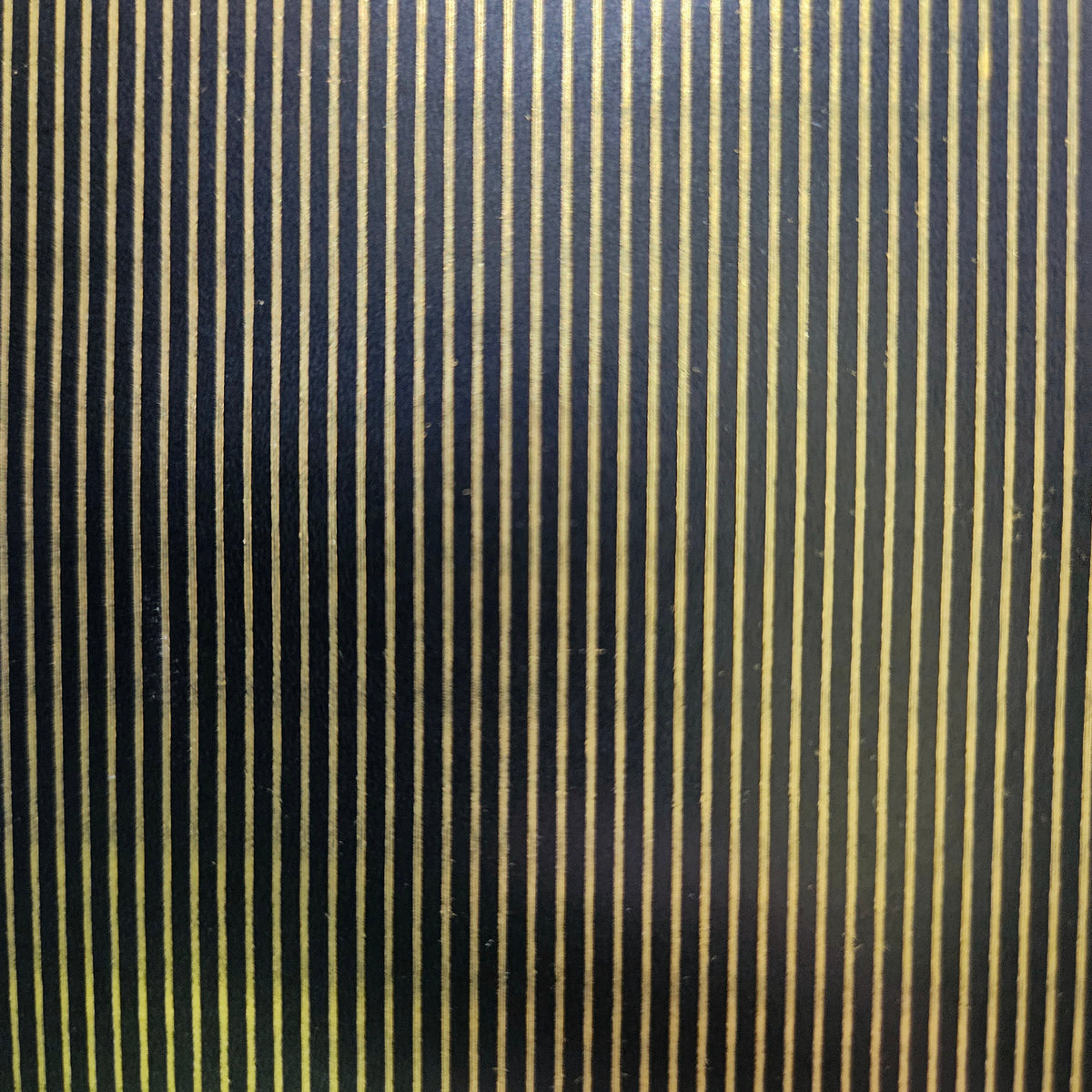 Black wrapping paper with gold pin stripes.