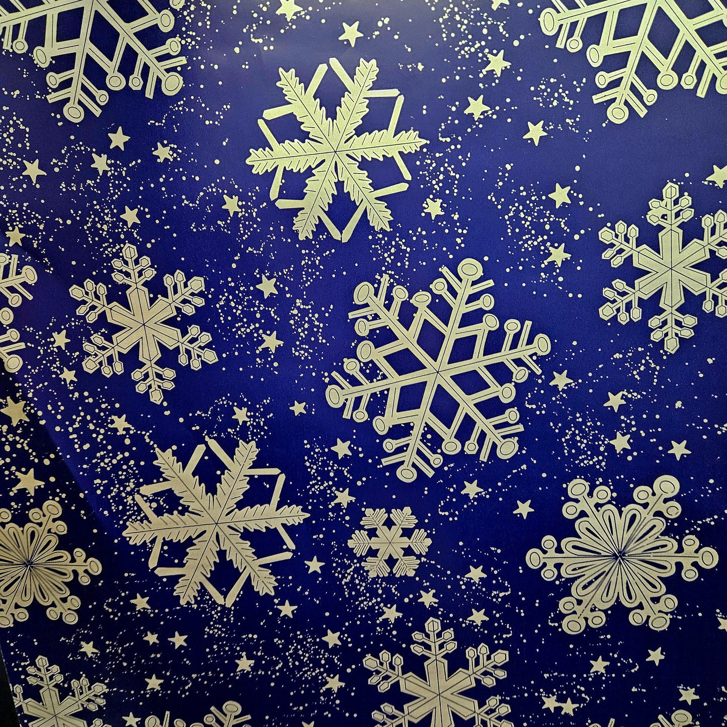 Christmas wrapping paper. Blue wrapping paper with large silver snow flakes.
