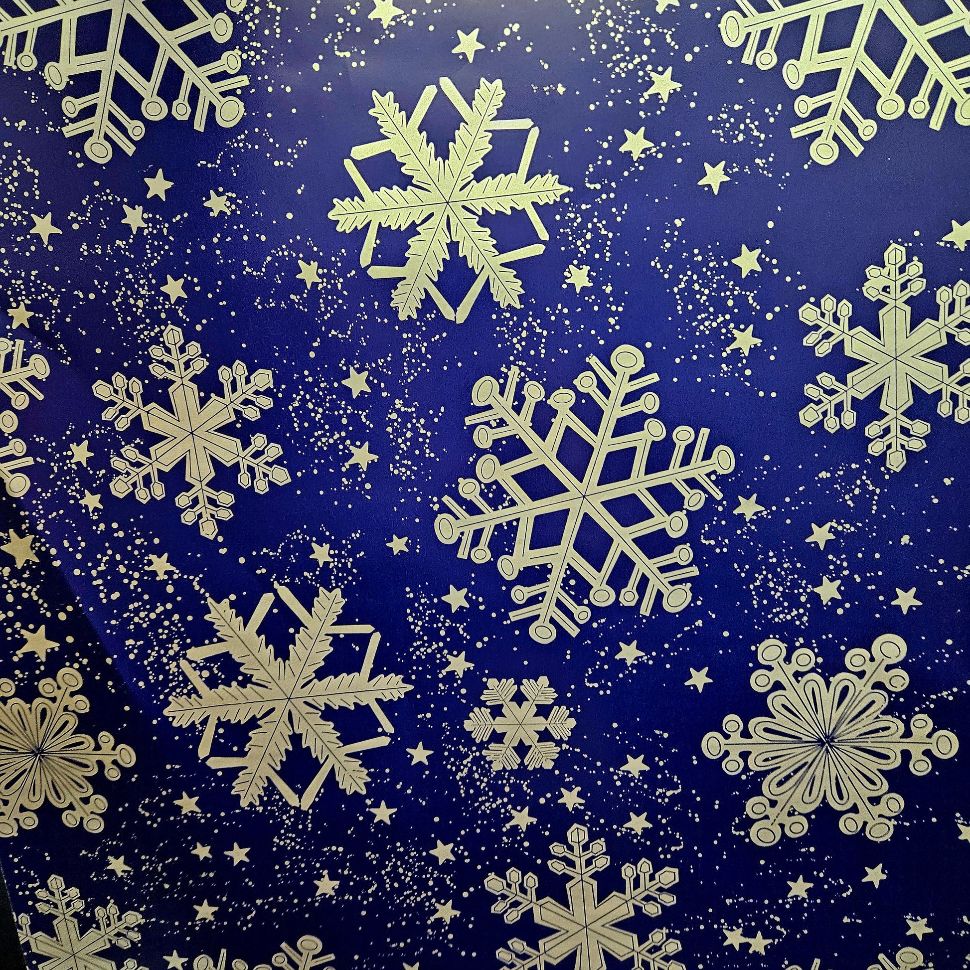 Christmas wrapping paper. Blue wrapping paper with large silver snow flakes.