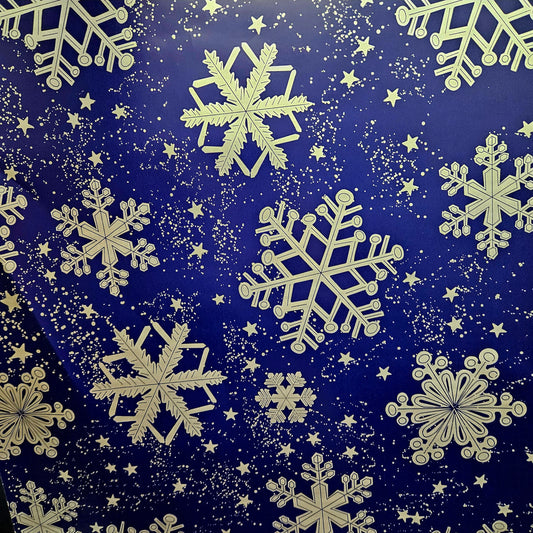 Christmas wrapping paper. Blue wrapping paper with large silver snow flakes.