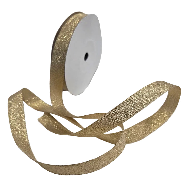Gold glitter ribbon on a white spool against a white background