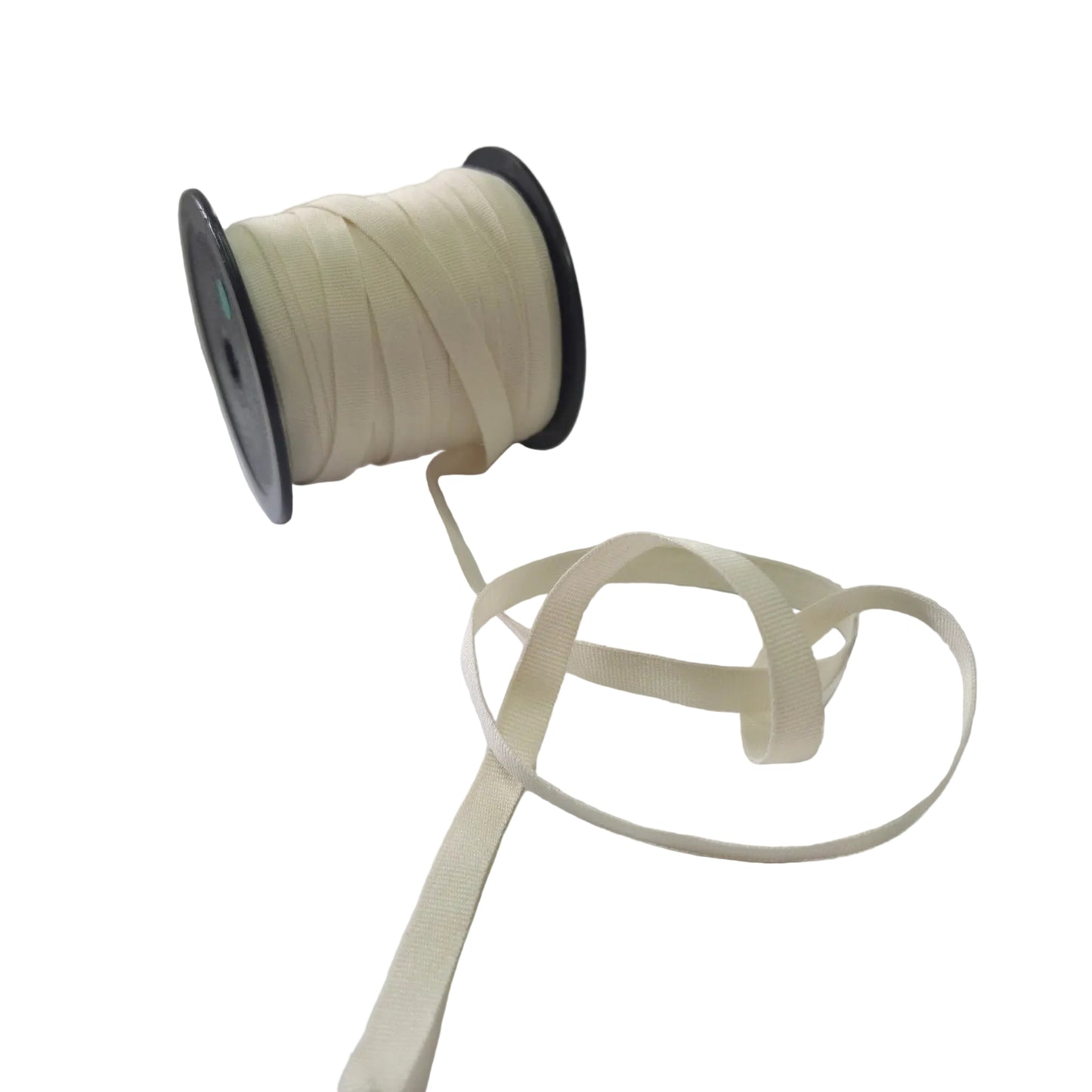 Spool of cream ribbon on a white surface