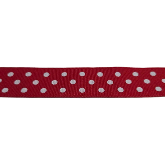 Red ribbon with white polka dots on a white background