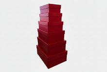 Load image into Gallery viewer, Stack of red boxes on a white background
