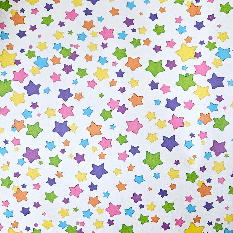 Wrapping paper with a pattern of mixed colourful stars on a white background