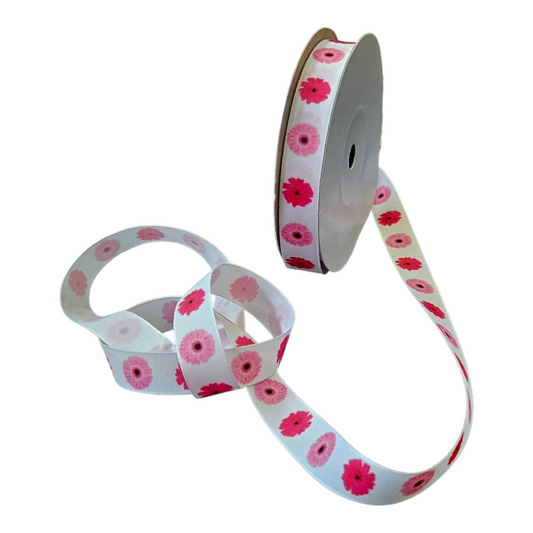 A 20 meter roll of white ribbon with pink flowers printed on it. 