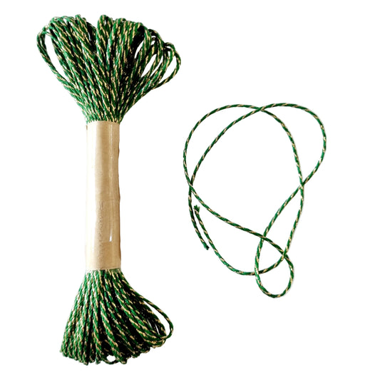 A spool of jungle green baker's twine with gold lurex, partially unspooled to show the colour and texture, placed on a white background.