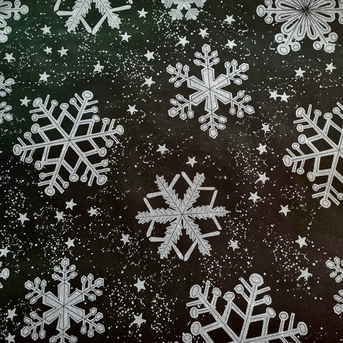 A patterned Christmas wrapping paper with large silver snowflakes on a black background.