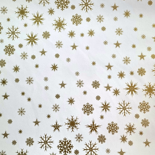White wrapping paper with small gold snow flakes pattern.